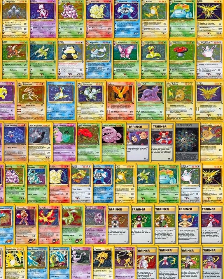 Collection of trading cards arranged in a grid layout, featuring various designs and holographic elements